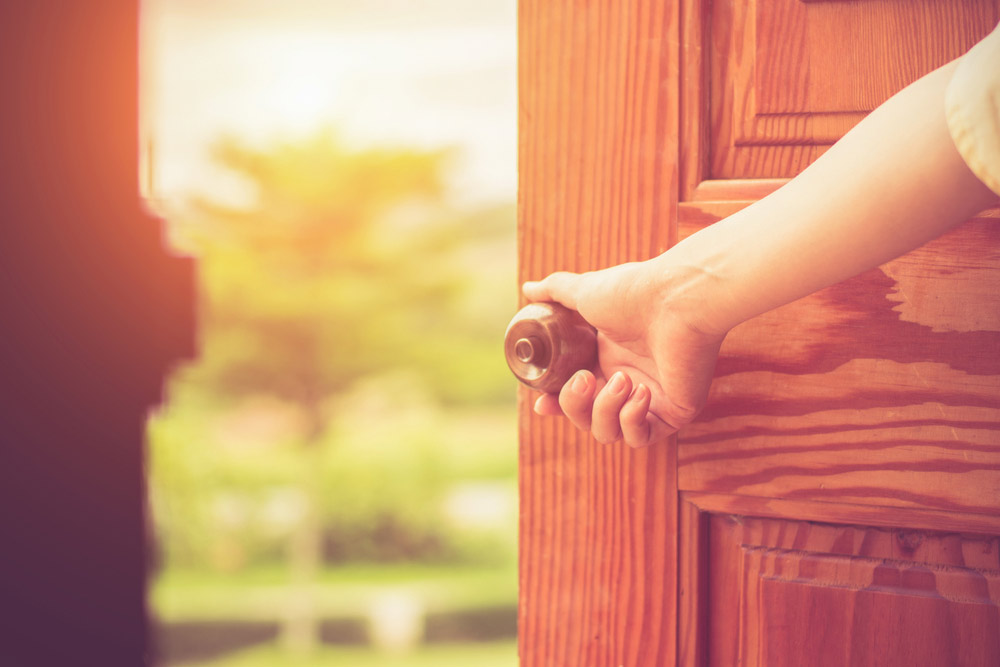 Woman's hand opening a door